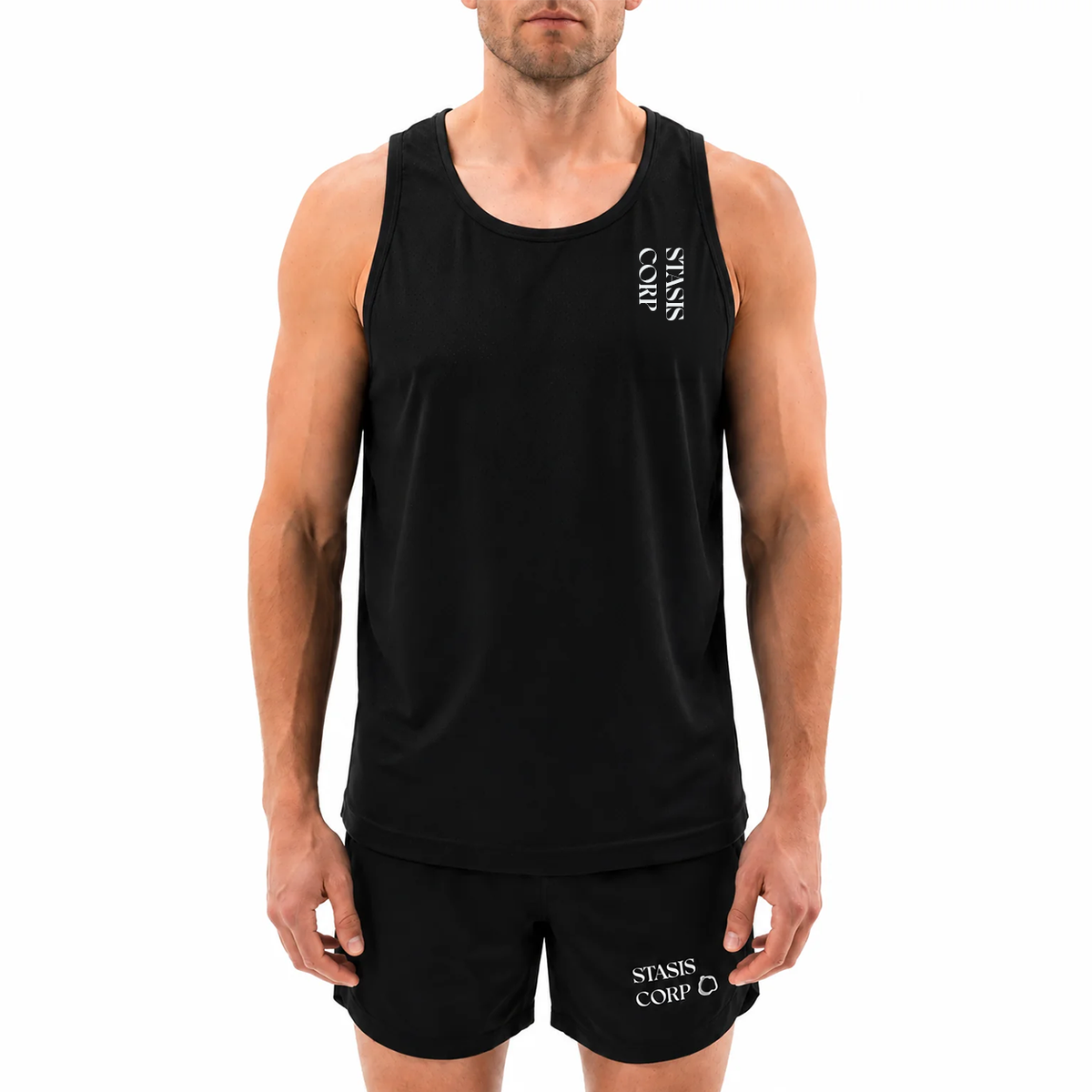 Model wearing the STASIS RD-1 running singlet in black, front view with vertical STASIS CORP chest print